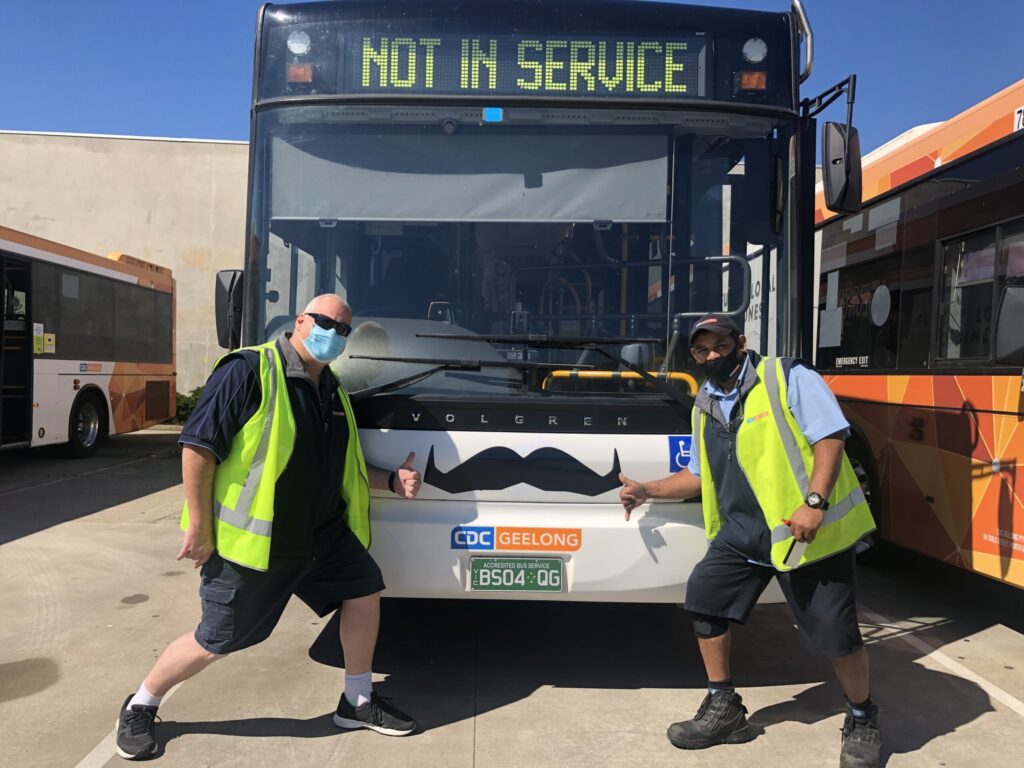 CDC Staff Standing In Front Of A CDC Geelong Bus With Movember Moustaches Scaled