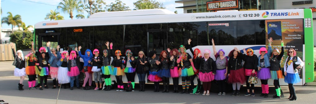 People Wearing Pink Dress Or Pink Wig In Front Of CDC QLD Bus
